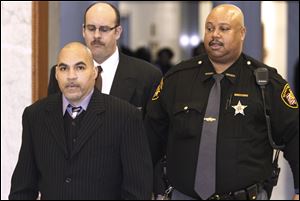 Ray A. Gott, left, is brought into court at the Lucas County Courthouse to begin his trial in the shooting death of Edward Christopher Lee and the injury of Sherlon McKenzie on April 4.