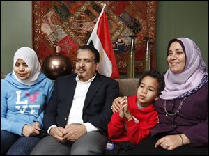 From left, Raghad Hassab-Elnaby, 14, Hassan Hassab-Elnaby, Yusuf Hassab-Elnaby, 7, and Amal Said watch the news of Hosni Mubarak's resignation in their Sylvania home. Mr. Hassab-Elnaby, a native of Egypt and UT professor, was in Egypt just as the protests began.