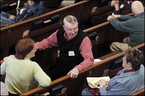 John Pike, center, of Maumee speaks with other members of the Maumee Valley Presbytery before a formal discussion on permitting gays and lesbians to be ordained.