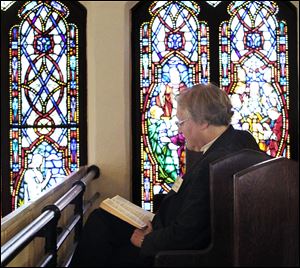 Darlene Bevelhymer of Bowling Green reads the Bible in a balcony pew before a meeting with the members of the regional body of the Presbyterian Church (USA).