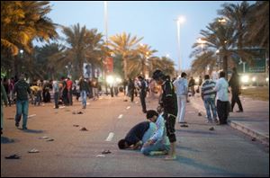 Protesters pray in the streets of Pearl Square in Manama, capital of Bahrain, and the scene of clashes with government forces. Protesters have turned defiant against the entire ruling system after the brutal crackdown there.