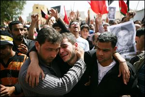 Family members mourn during a funeral in Sitra, Bahrain, for a slain anti-government protester.