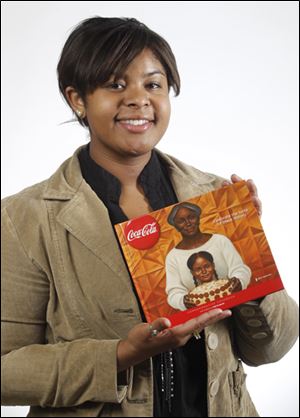 Brooke Campbell with the Coca-Cola cookbook featuring her poetry.