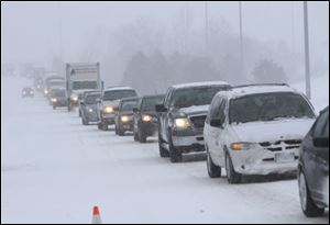 Traffic backs up on northbound U.S. 23 after a semi-tractor trailer jack-knifed during Friday's snowstorm.