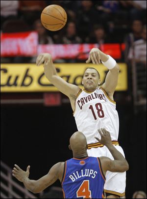 Cleveland’s Anthony Parker passes over New York’s Chauncey Billups.