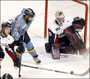 The Walleye's Jeremy Tucker tries to get to the puck and blast it past Kalamazoo goalie Riley Gill.