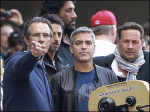 Actor George Clooney, center, plans a shot during filming of 'Ides of March' in Cincinnati. Clooney is directing the film and starring as a Democratic governor running in the presidential primaries.