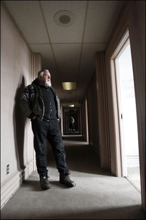 Peter Hatas stands in a second-floor hall of the St. James Hotel at Lagrange and North Summit streets. The deadline to close the deal has passed and the owner, the American Maritime Officers, isn't sure it will grant Mr. Hatas an additional 30-day extension.