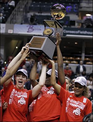 From left, Sarah Schulze, Jantel Lavender, and Brittany Johnson show off the Big Ten trophy.