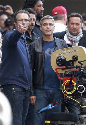 Actor George Clooney, center, plans a shot during filming of 'Ides of March' in Cincinnati. Clooney is directing the film and starring as a Democratic governor running in the presidential primaries.
