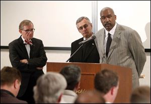 OSU president E. Gordon Gee, left, Buckeye coach Jim Tressel and athletic director Gene Smith talk at Tuesday's  press conference.