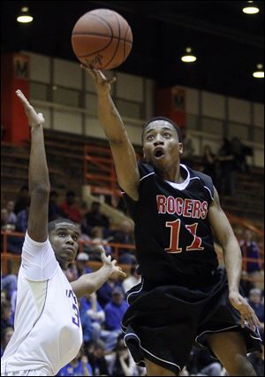 Damond Powell of Rogers goes to the basket against  Henry Newson of Waite in a Division II district semifinal Wednesday night at Anderson Arena. Powell led the Rams (13-5) with 19 points.