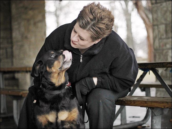 Mona Guinaugh was given responsibility of Darby by Planned Pethood Inc., as a foster parent after the dog suffered a foot-long chemical burn on its back. Miss Guinaugh said Darby is 'a wonderful dog and so gentle.' When the foster period ended she adopted the Rottweiler.