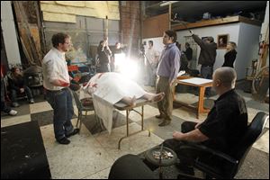 Camera area ready to roll while actors Chad Foltz, left, Ed Bazydlo, right, and Christopher Wietrzykowski, center in chair, rehearse a scene while shooting the film 