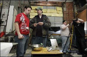 Terry McDaniel II, left, goes over props with writer/director Jordan Salkil during filming of 