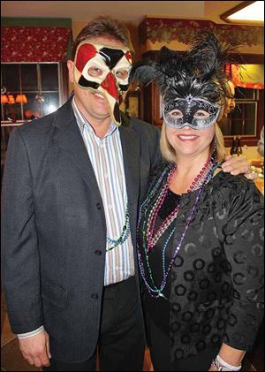 Rick and Annie Strause wore masks they purchased in Venice for the party.