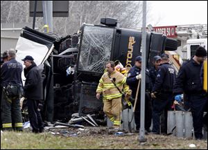 Emergency personnel investigate the scene of a bus crash on Interstate-95 in the Bronx borough of New York Saturday.