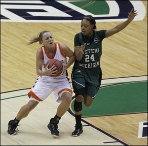 BGSU's Tracy Pontius maneuvers around E. Michigan's Tavelyn James during 2011 Mid-American Conference women's basketball final at Quicken Loans Arena in Cleveland. 
S2 S2pontius 3.26