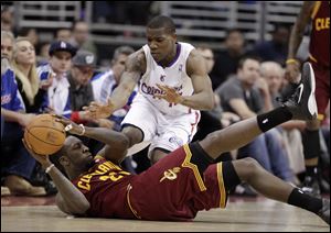 Cleveland forward J.J. Hickson, bottom, looks to pass after retrieving a loose ball against the Los Angeles Clippers.