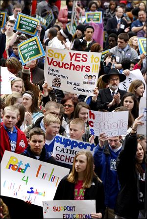 A rally at the Statehouse in Columbus draws more than 1,000 to show support for Gov. John Kasich's proposal to quadruple the number of school vouchers.