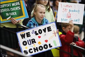 Clare Aman, 12, a student at St. Mary School in Delaware, Ohio, joins other school-choice advocates at the Statehouse to back the governor's proposal to expand tuition vouchers and charter schools.