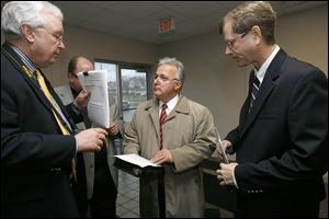 Terry Casey, left, a GOP operative who has participated in other elections investigations; George Sarantou, and Lucas County Republican Chairman Jon Stainbrook gathered Nov. 30 at the Board of Elections for the commissioner’s race ballot recount.