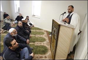 Imam Ahmed Abou Seif leads a prayer service at the Toledo Muslim Community Center on West Sylvania Avenue in a building that formerly housed the J. Jeffrey Fretti mortuary.