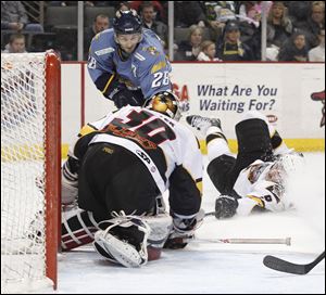 Toledo's Mike Hedden (28) has his shot stopped by Cincinnati goalie Brian Foster and a sliding Mathieu Aubin Sunday.
