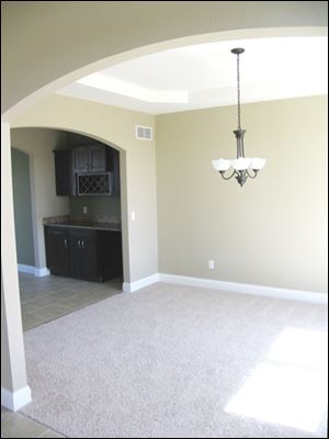 Archways denote the entrance to the formal living room.
