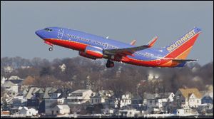 A Southwest Airlines plane takes off from Boston. Southwest had a plane flying from Phoenix to Sacramento undergo rapid decompression.