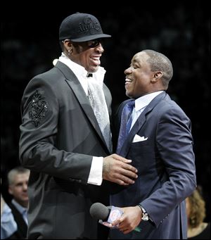 Former Pistons teammates Dennis Rodman, left, and Isiah Thomas share a laugh during the halftime ceremony to retire Rodman's No. 10 jersey.
