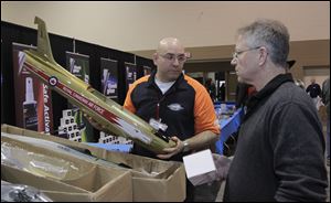 Andrew Kondor, left, of Kondor Model Products, Thunder Bay, Ont., speaks with Arnold Black of Port Huron, Mich., at Mr. Kondor's booth, one of 375 this weekend at SeaGate Convention Centre.