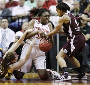 Texas A&M players Kelsey Assarian, left, and Sydney Carter (4) fight for a loose ball against Stanford's Nnemkadi Ogwumike (30).