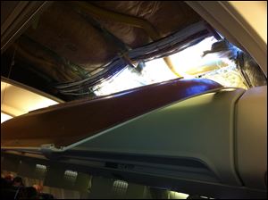This photo provided by a passenger shows an apparent hole in the cabin on a Southwest Airlines aircraft Friday.