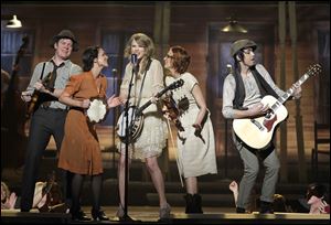 Entertainer of the year Taylor Swift, center, performs with bandmates.