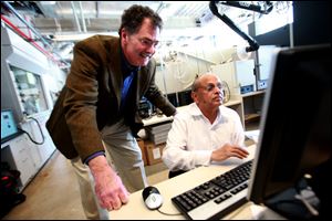 Steve Salley, left, a professor at Wayne State, working with Srinivasan Venkatesan, says automotive technology is changing rapidly.