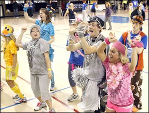 
Nadean Borders, left, in silver, Mick Earley, center, and Sarah Gruss, right, in pink, keep dancing in the recreation center to help sick and injured children at Mercy Children's Hospital in Toledo.