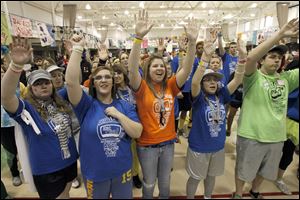 Brittany Bowersock, left, Jackie Jamiot, Alex Frederick, and Stephanie Greco join the crowd in raising their arms to catch a free T-shirt at BGSU's 32-hour marathon. 