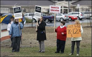 Members of the Bedford Education Association including from front left, Jane Newmeyer, a music teacher, Clara Talip an art teacher, Linda Perry, a first and second grade teacher, and Judy Herr a kindergarten teacher, conduct an informational picket outside Monroe Road Elementary School in Lambertville.