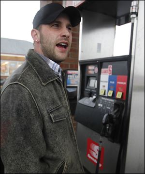 James Knight pumps gas at Speedway in Maumee. He moved to Port Clinton from Toledo partially because of gas prices.