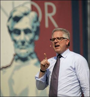 Conservative commentator Glenn Beck speaks to thousands gathered below the steps of the Lincoln Memorial in Washington during the 
