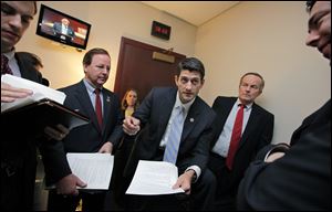House Budget Committee Chairman Paul Ryan (R., Wis.) works with Republican members of the committee on Capitol Hill Tuesday. He is flanked by Rep. Tom McClintock (R-Calif.), right, with Rep. Bill Flores (R., Texas).
