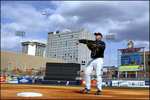 Mud Hen's infielder Scott Thorman tosses a practice ball back toward home. Toledo begins the season Thursday at Louisville.