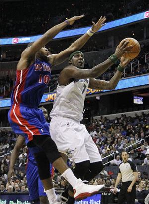 Washington's' Andray Blatche (7) shoots against Detroit's Greg Monroe 