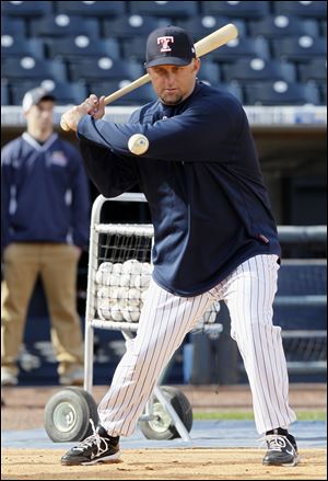 Mud Hens manager Phil Nevin bats during infield practice.