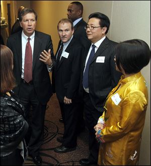 Ms. Yuan, right, Mr. Guo, and Mr. Prephan were on hand for Gov. John Kasich's recent appearance in Perrysburg. Mr. Guo is a translator and deal broker; Mr. Prephan is a local businessman with ties to China.
