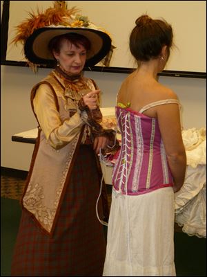Kathy Dowd, left, and Patricia Crosby prepare to model Victorian fashion and lingerie.