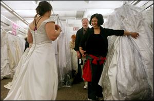Mary Fitzgerald, from New Brunswick, N.J., shows a bridal gown to her parents Pat, center, and Sue Fitzgerald, from Utica, N.Y., during the 