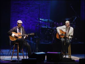 James Taylor, right, performs with his son, Ben, at the Stranahan Theater April 2.
