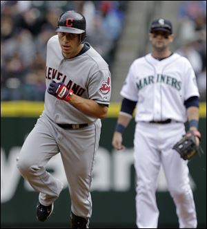 Seattle Mariners second baseman Adam Kennedy, right, watches as Cleveland Indians' Asdrubal Cabrera rounds the bases on a home run in the first inning.